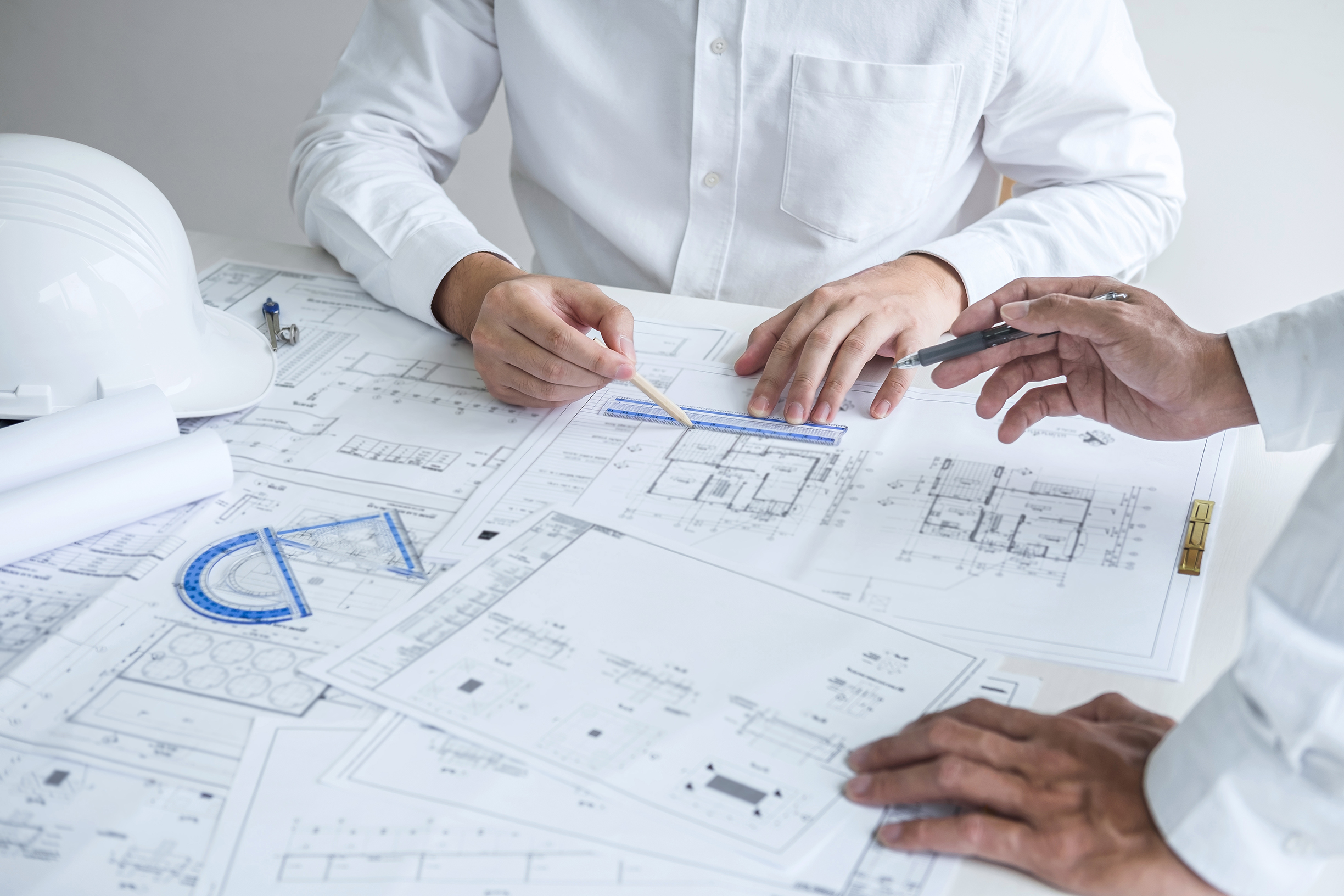 Construction engineering or architect discussing a blueprint and